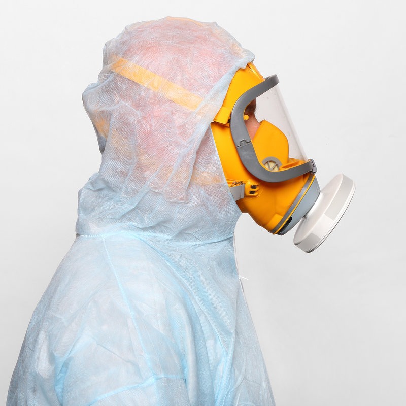 Man in protective clothing with respirator. Infection control concept.