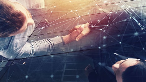 Handshaking business person in office with network effect. conce Handshaking business person in office with network effect. conce
