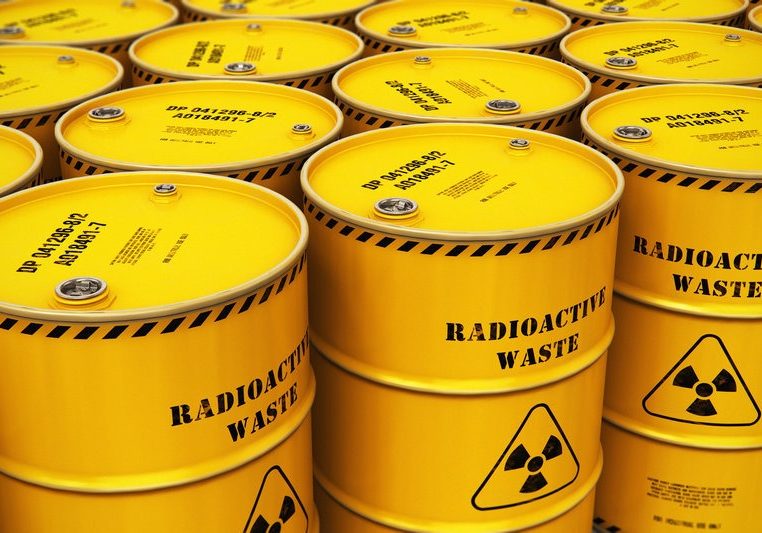 Group of stacked yellow drums with radioactive waste