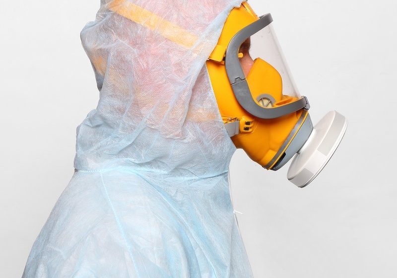 Man in protective clothing with respirator. Infection control concept.